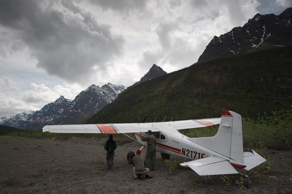 Aircraft on a remote Alaska airstrip surrounded by mountains